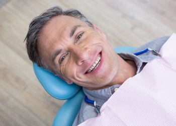 Smiling man laying in dental chair