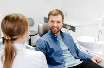 Man smiling at his dentist after receiving dental services in Gorham