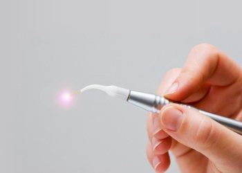 Hand holding a pen like dental laser device