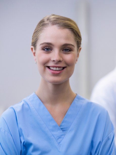 Smiling Gorham dental team member in light blue scrubs