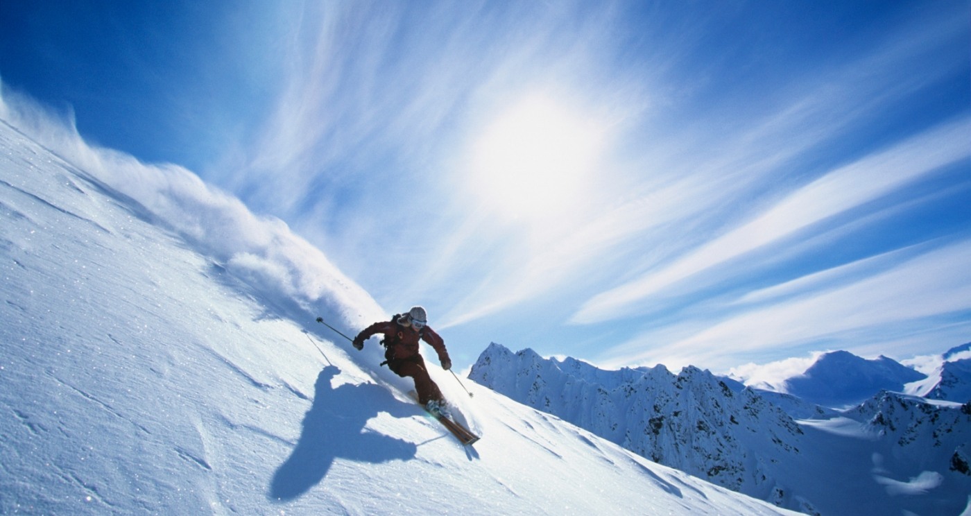 Person skiing down a snow covered mountain