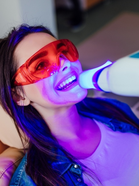 Woman in dental chair getting professional teeth whitening in Gorham