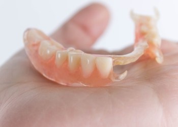 hand holding a partial denture