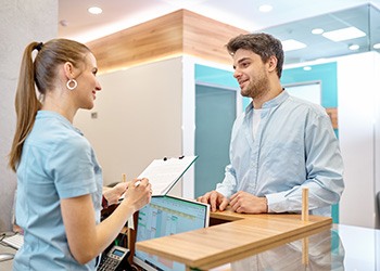 a patient speaking with a receptionist