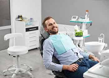 Man sitting back in chair and smiling