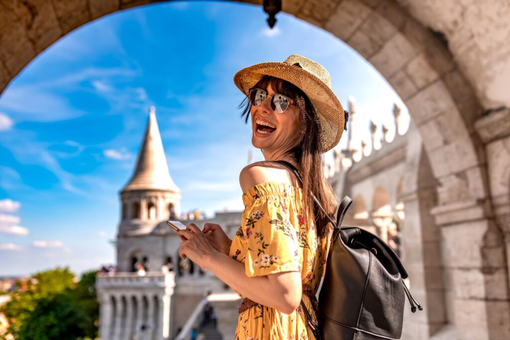 A female tourist smiling.