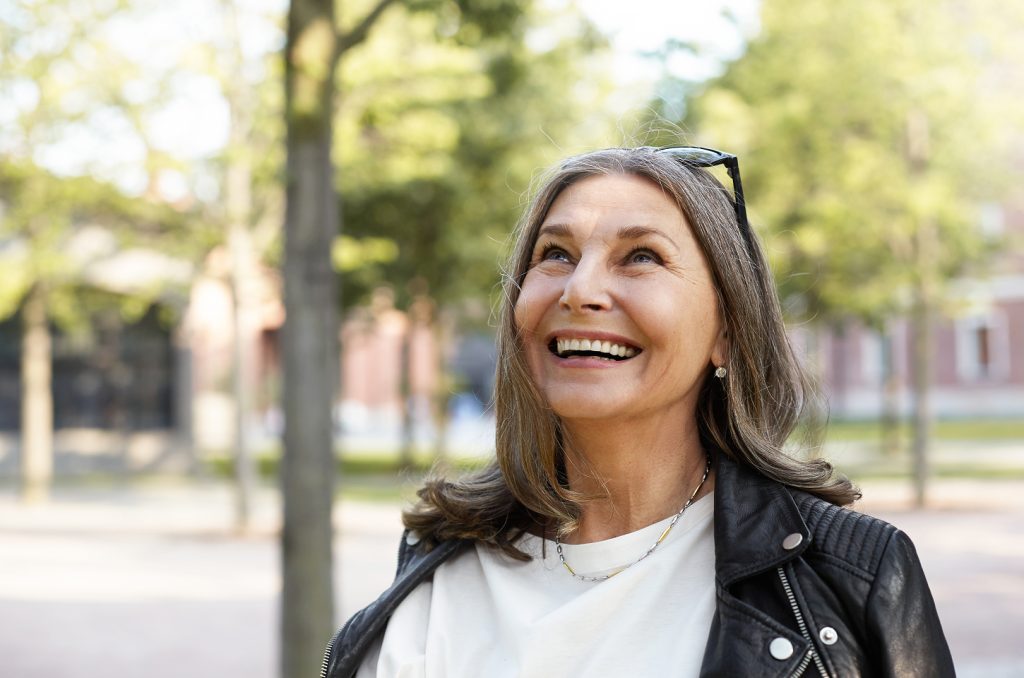 Senior woman smiling after a successful dental implant aftercare recovery at Morgan Dental Care in Gorham, ME